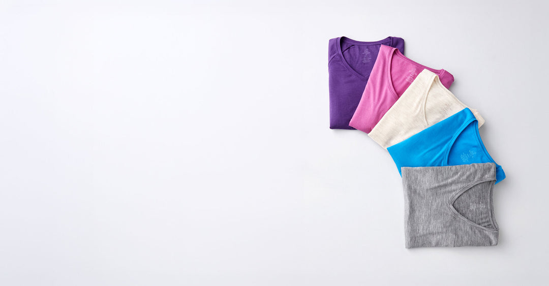 stack of Mia tees on grey background