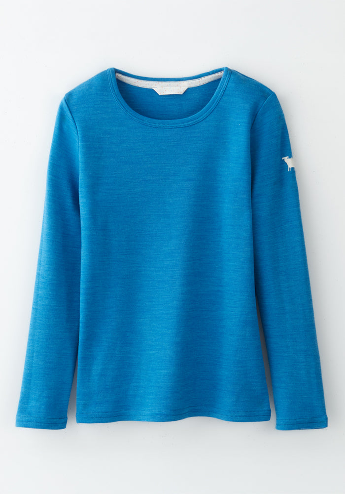 The Woolx Kids Explorer Base Layer Top in Blue Razz features a crew neck, long sleeves, and a small white embroidered animal on the upper left sleeve. Made from soft Australian Merino wool, the top is shown laid flat on a white background.