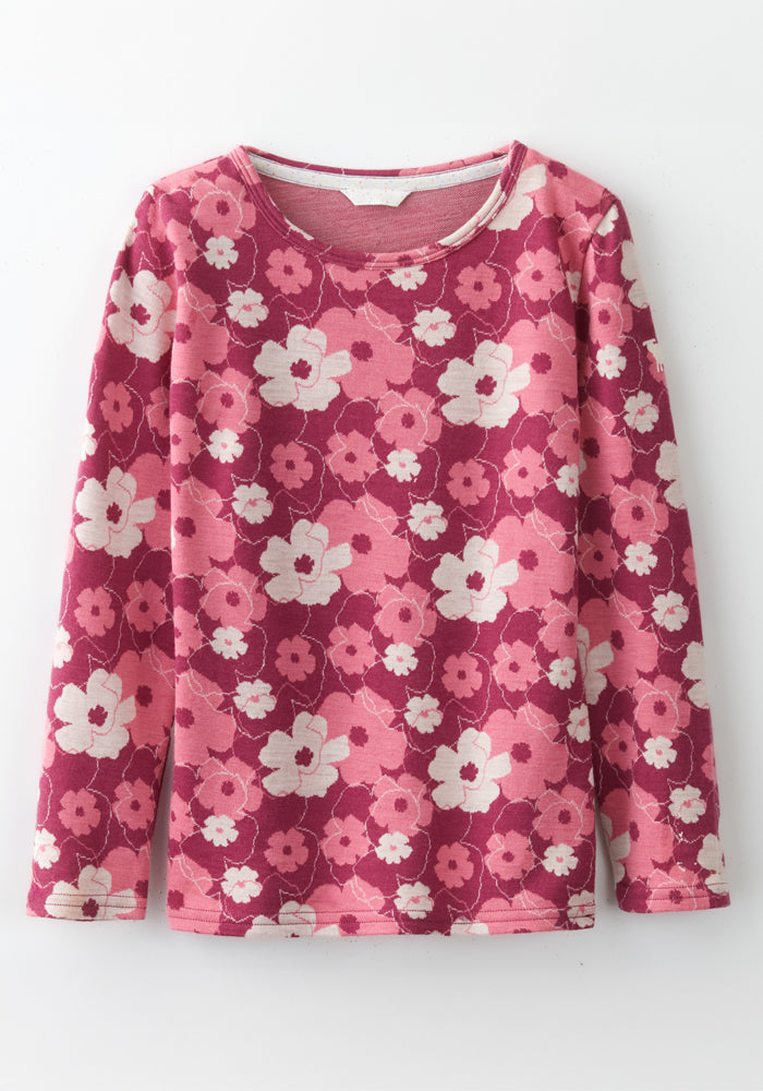 The Woolx Kids Explorer Base Layer Top - Rosie Posie is a long-sleeve, relaxed-fit kids shirt with a pink, red, and white floral pattern, round neckline, and soft Australian Merino wool, shown laid flat on a white background.