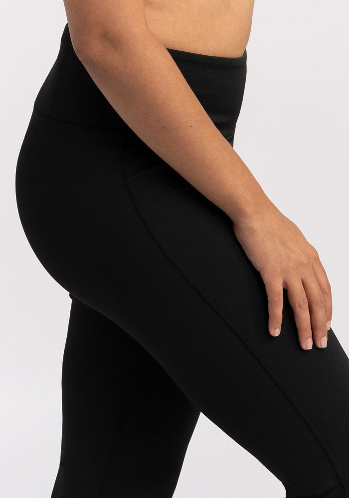 Model wearing Woolx Marissa Tall Pants in black, shown mid-torso to knee against a light background.
