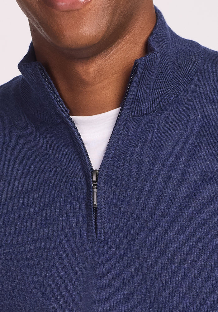 A close-up of a person wearing the Woolx Enzo Quarter Zip - Twilight Storm over a white t-shirt, zipper partially undone and only the lower face showing—an ideal breathable, moisture-wicking midweight layer.