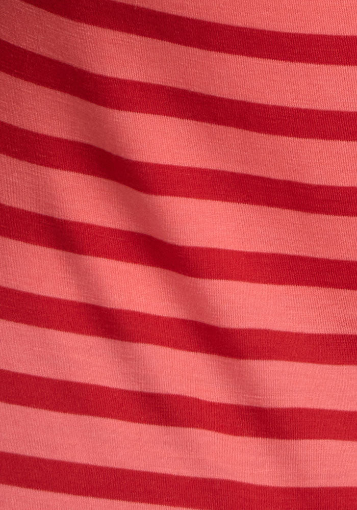The Woolx Bella Tunic Top in Wildberry Stripe features red and pink stripes with a gentle wave fold detail.