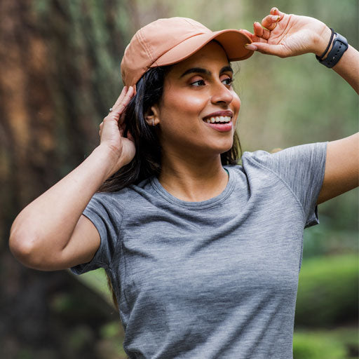 Model wearing graphite Addie and salmon Frankie hat