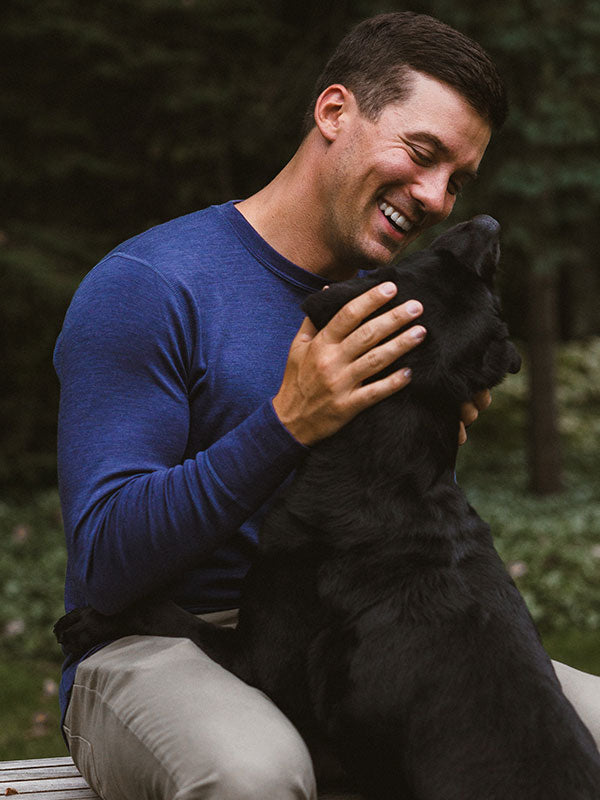 Model wearing Blue woolx top petting a dog