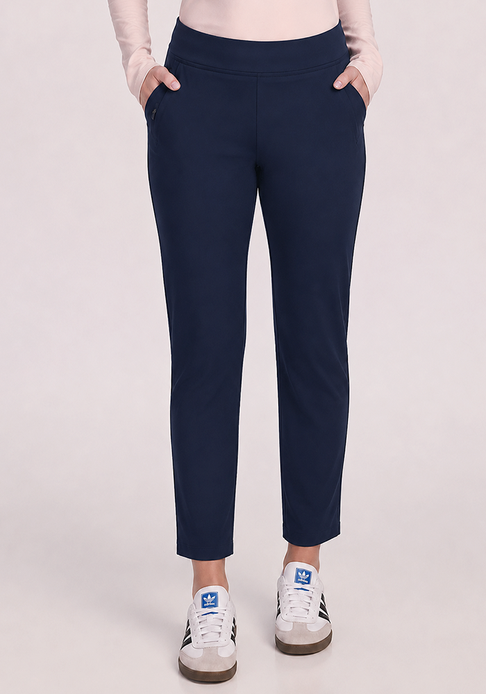 Wearing Woolx Nicole Ankle Pants in Deep Navy, a light pink top, and white sneakers with blue logos.