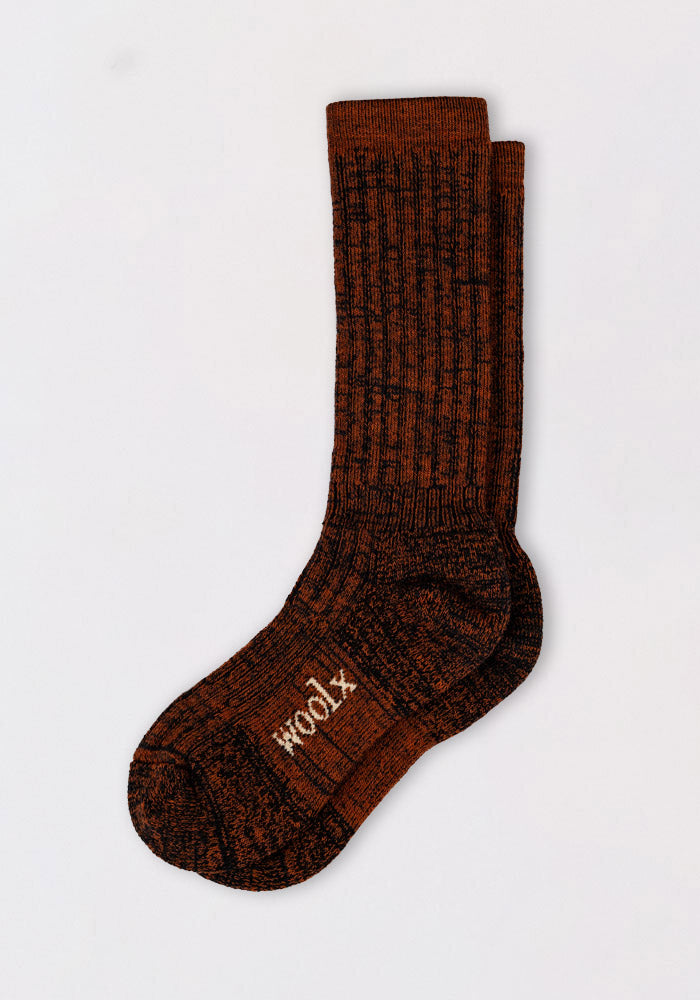 A pair of Woolx Mens Joey Mid Calf Socks in Cinnamon Spice, featuring a brown and black marled knit and ribbed texture, stacked on a white background. “WOOOL” is printed on the sole, ideal for cold weather wear.