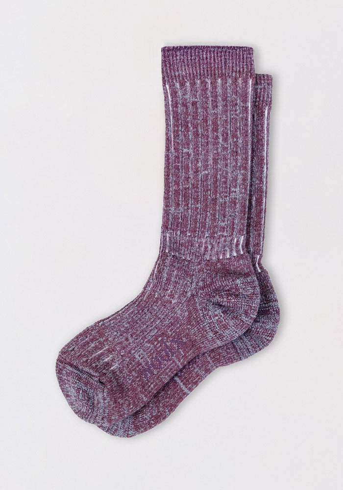 The Womens Joey Mid Calf Socks - Wildflower by Woolx feature a purple and white speckled design with a ribbed texture—these cozy merino wool socks are neatly folded and perfect for any occasion.