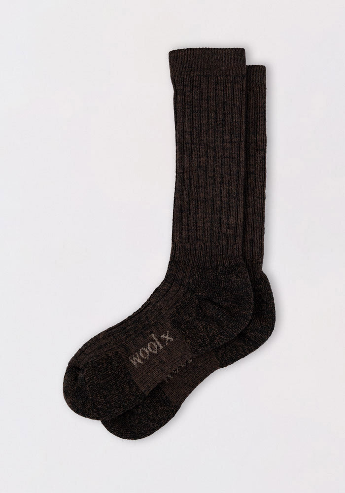 The Womens Joey Mid Calf Socks by Woolx, in Dark Espresso, feature a ribbed design and warm Merino wool with "WOOL" stitched on the sole, displayed against a plain light background.
