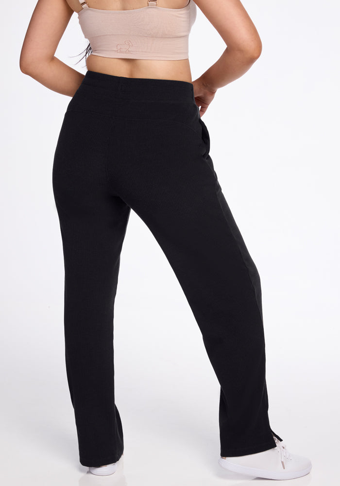 Model in beige top and Woolx Luca Petite Pants - Black, white shoes, shown from the back.