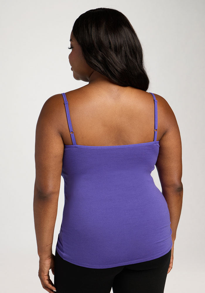 Woman with long dark hair wears the Woolx Teagen Cami With Shelf Bra in Berry Indigo, shown from the back.