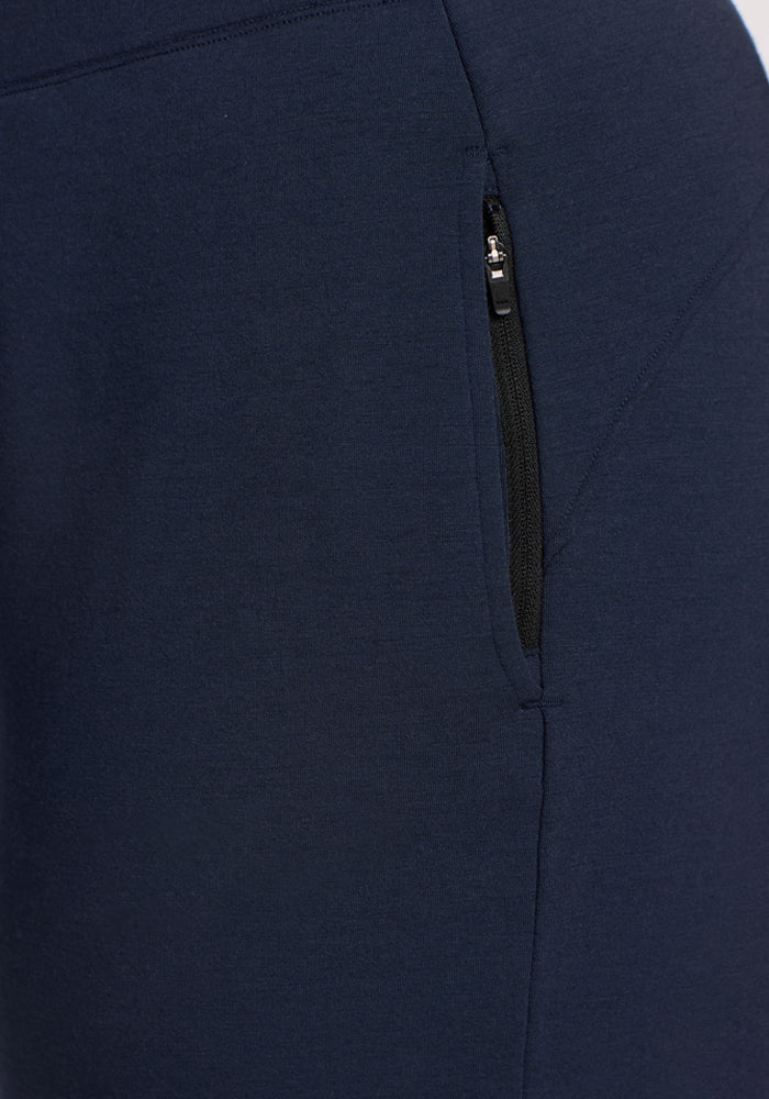 Close-up of Woolx Brynn Pants in Deep Navy, featuring a side pocket with a black zipper partially unzipped. The soft, textured Duralite merino fabric delivers comfort and durability ideal for travel pants.