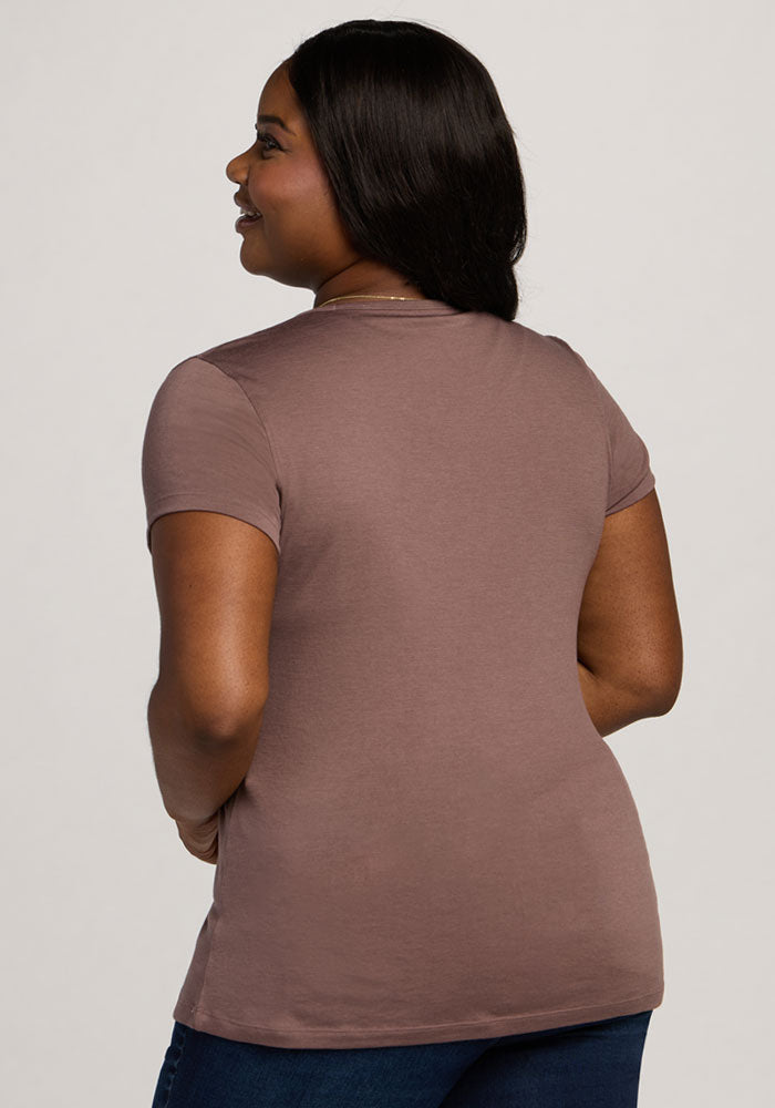 A woman with long dark hair wears the Woolx Addie Crew Neck in Peppercorn and jeans, back to camera.