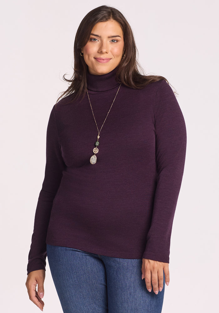 A woman wearing the Woolx Peyton Turtleneck in Deep Plum. 