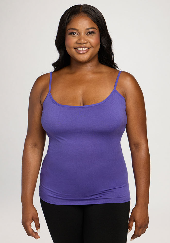 Woman in the Woolx Teagen Cami With Shelf Bra in Berry Indigo, smiling against a plain light background. 