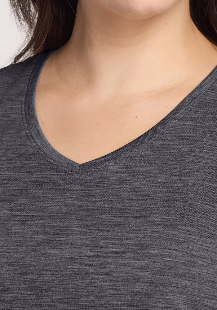 Close-up of a person wearing the Woolx Junie V Neck in Cinder Melange, showing its relaxed fit, V-neckline, and soft Merino wool fabric against a neutral background.