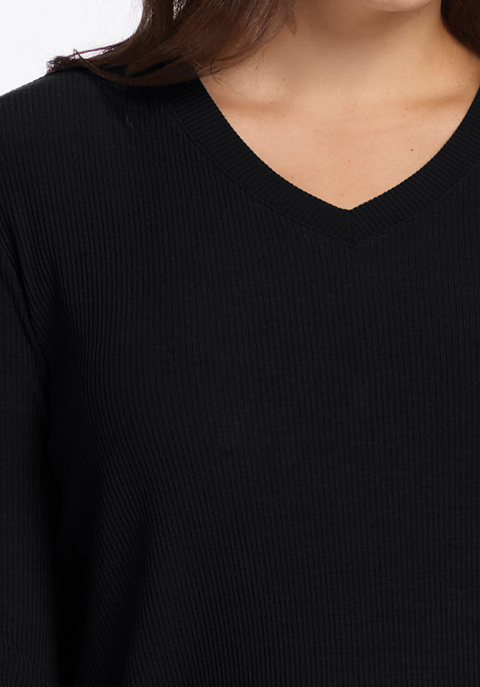 Close-up of a person in the Woolx Evie Petite Tunic in black, highlighting its V-neck collar and ribbed Merino wool.