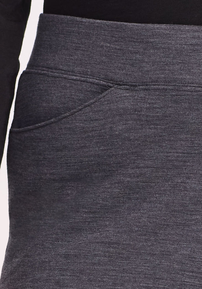 Close-up of the Woolx Ellie Wide Leg Pants in Cinder Melange, featuring a side pocket and thermal replacement fabric for warmth and style. Shown with a black top, only part of the person's arm and waist are visible.